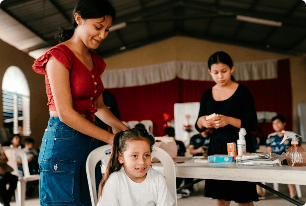 Youth mentor supporting a child during an ORPHANetwork youth development program