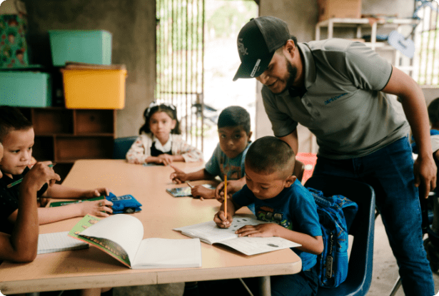 Teacher supporting children with learning activities in an ORPHANetwork education program